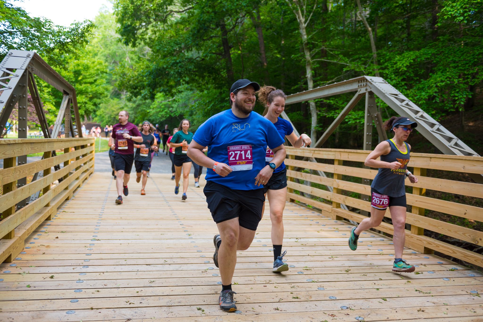 Participants running across bridge