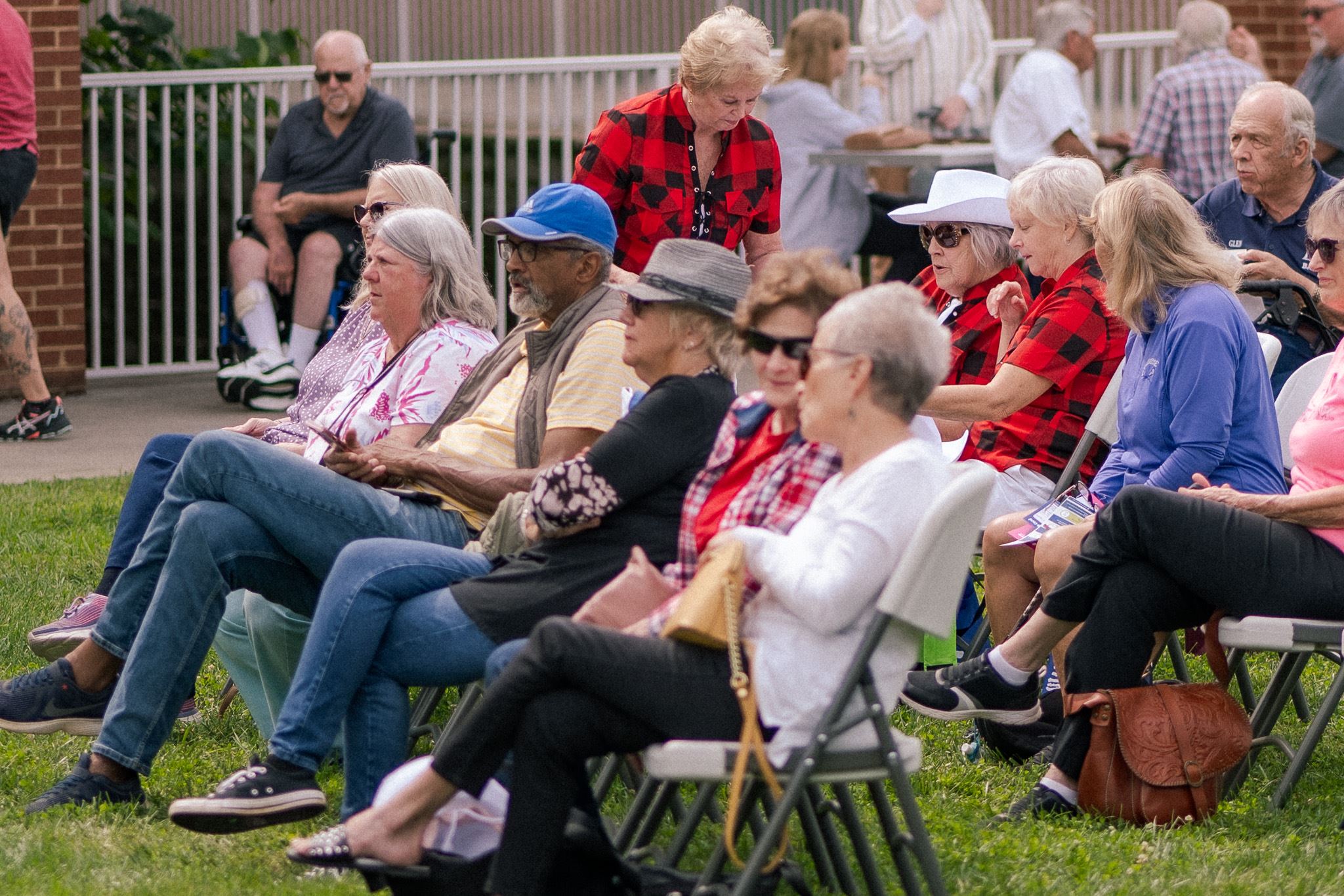 People sitting in lawn chairs on the grass