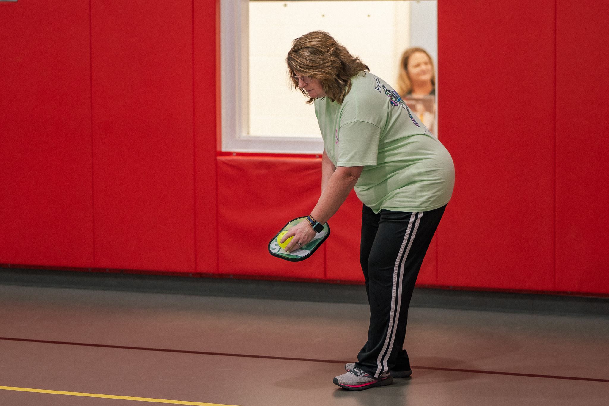 Someone getting ready to serve in a game of pickeball